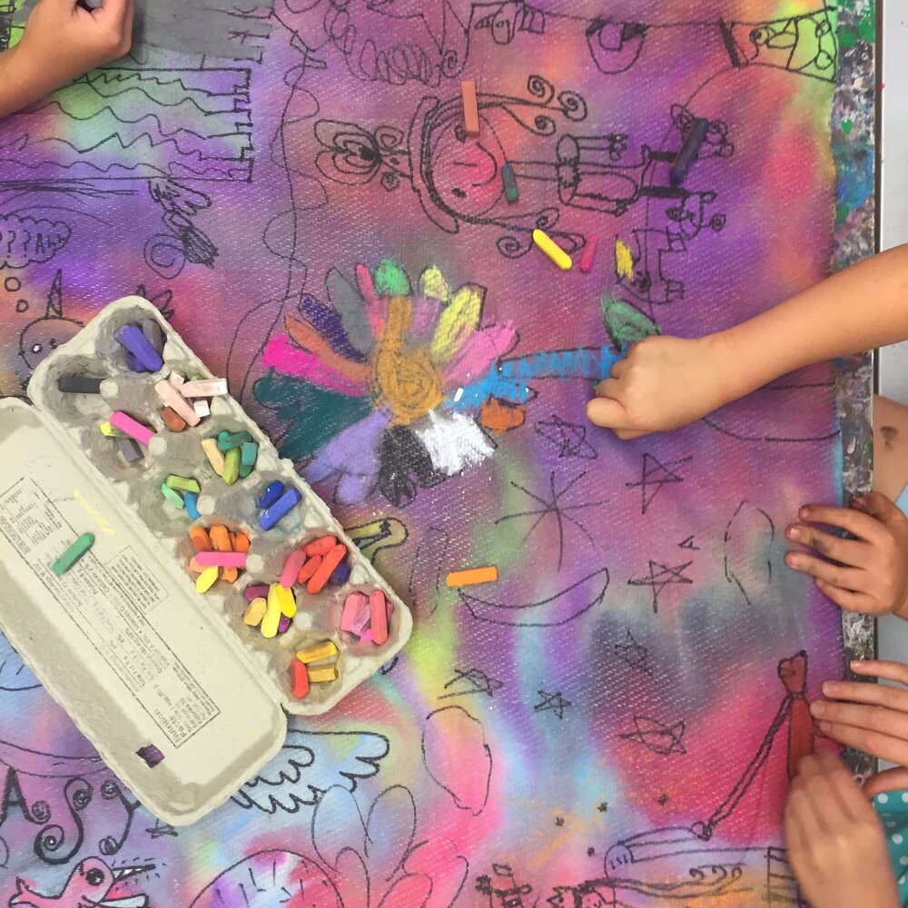 Teens working on mixed-media art at an outdoor table at Pachis art studio, Linda Vista, San Diego