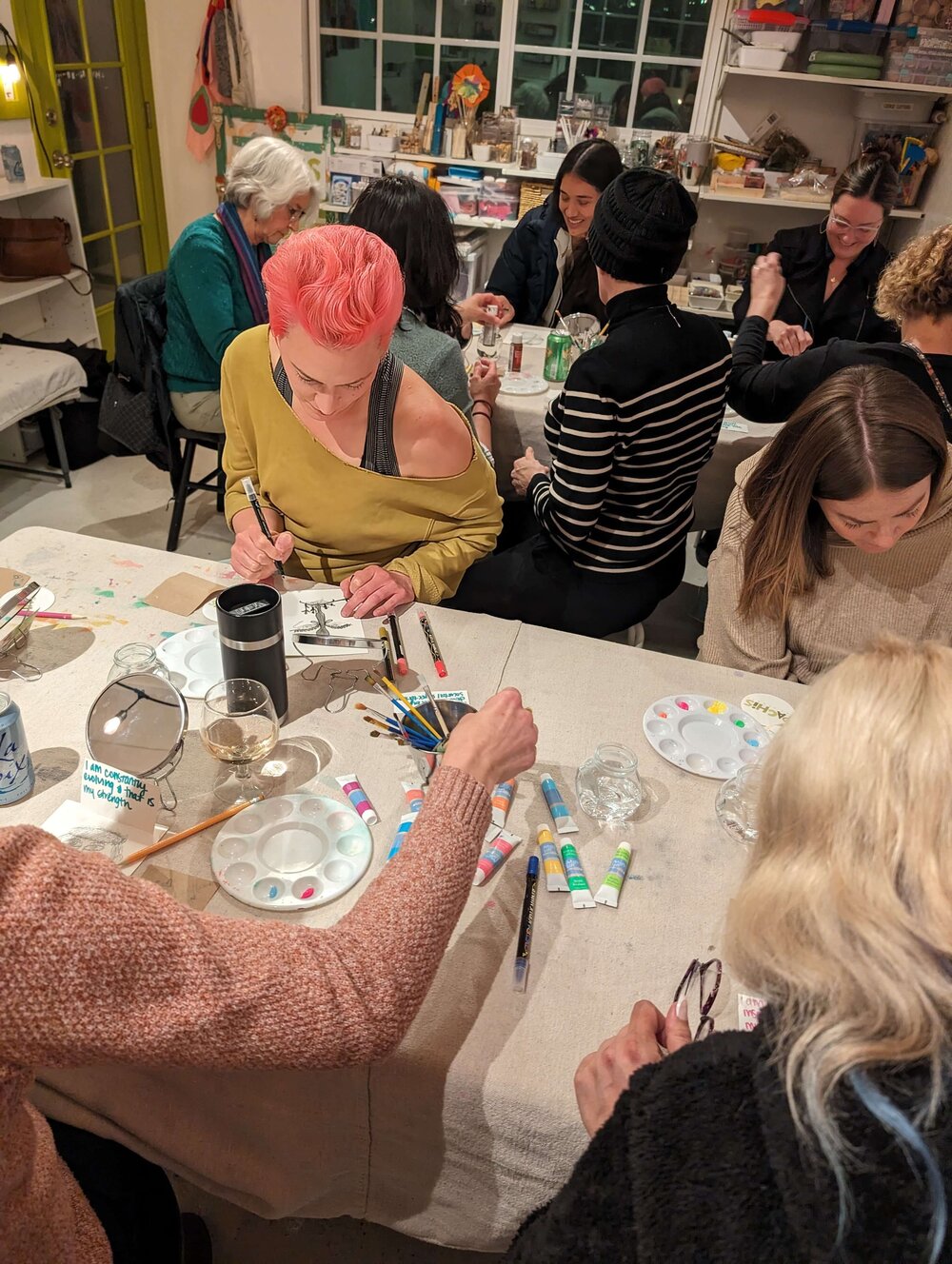 A woman working on a themed therapeutic art project in a Creative Hour workshop at Pachis art studio, Linda Vista